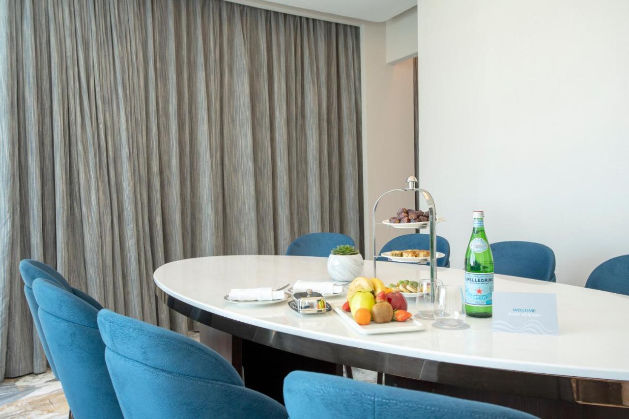 Century Marina Hotel - Lusail Bagian luar foto A table with a bottle of mineral water