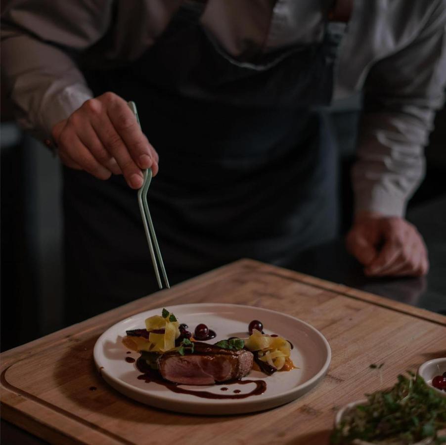 Century Marina Hotel - Lusail Bagian luar foto A chef plating a dish