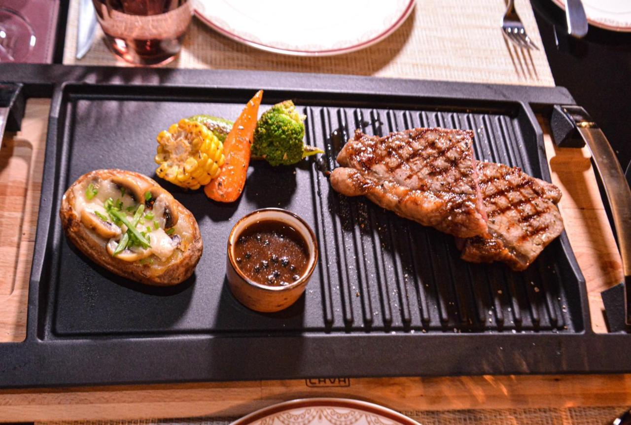 Century Marina Hotel - Lusail Bagian luar foto A steak prepared on a griddle