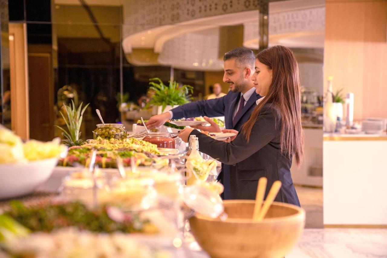 Century Marina Hotel - Lusail Bagian luar foto A buffet at a hotel